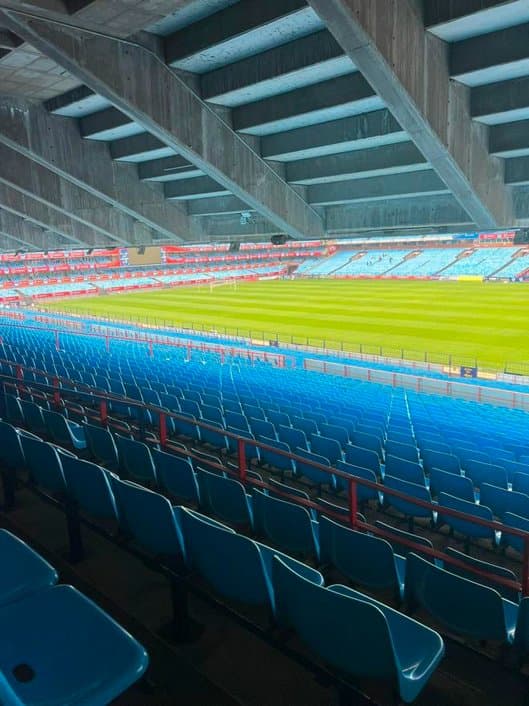 Stadium stand with rows of blue seats cleaned before match day